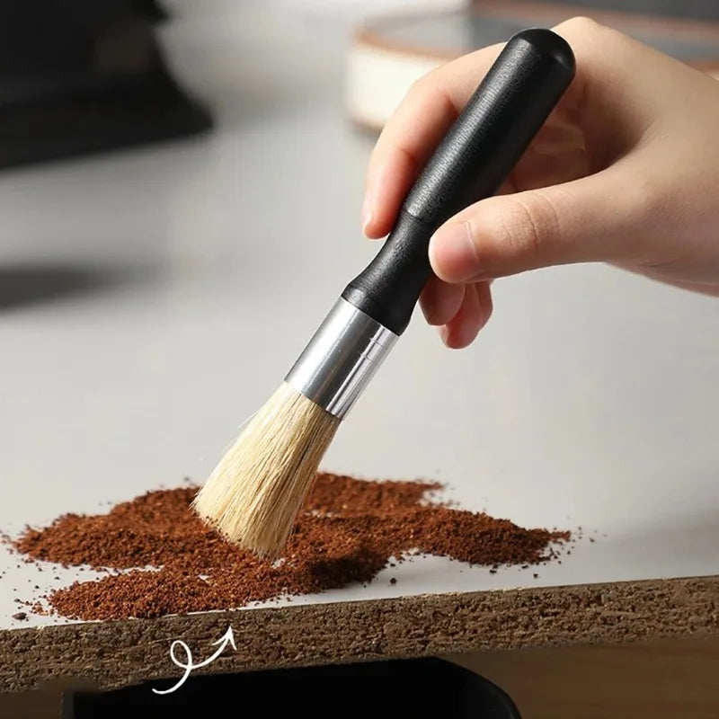 Brosse de nettoyage pour machine à café à manche et corps en bois, poils fixés par fil métallique, sur fond blanc.