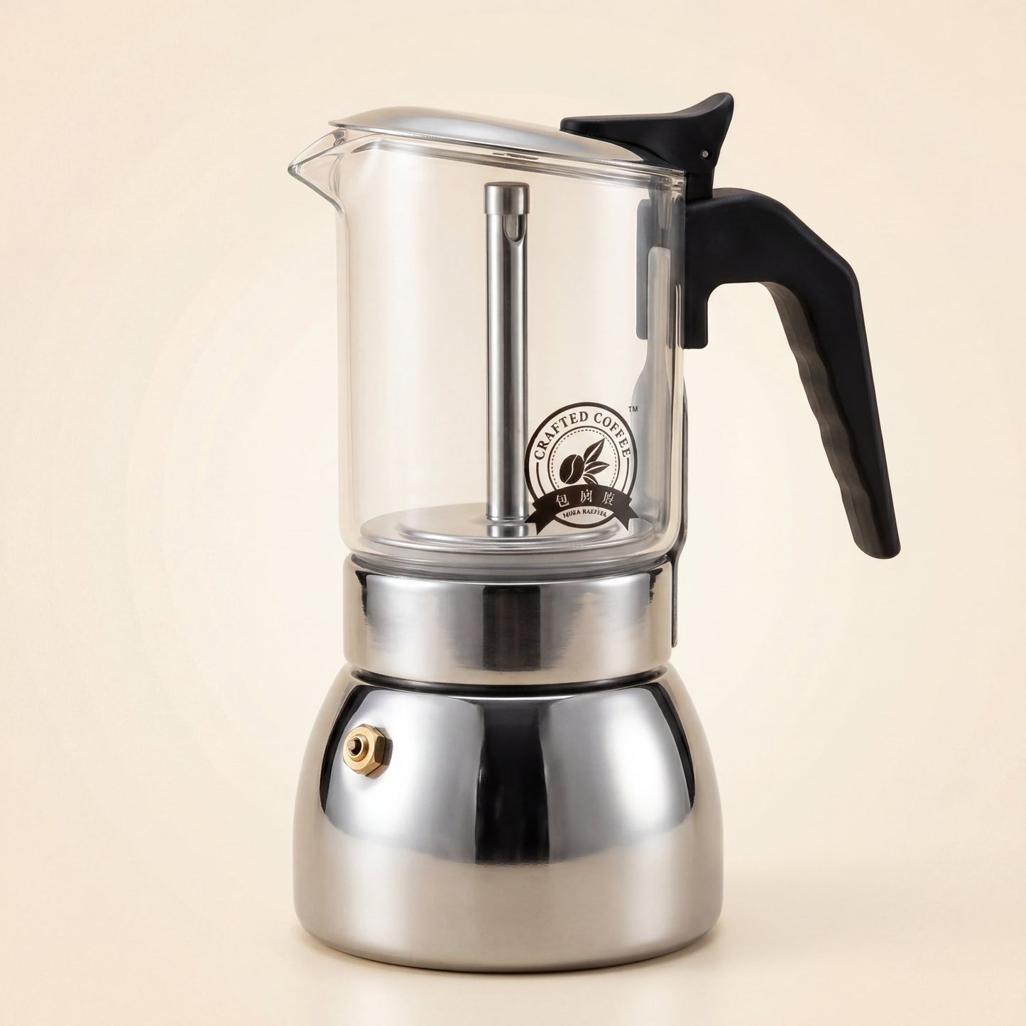 Cafetière italienne à chambre supérieure en verre borosilicate et base en inox, poignée noire, vue de trois-quarts.