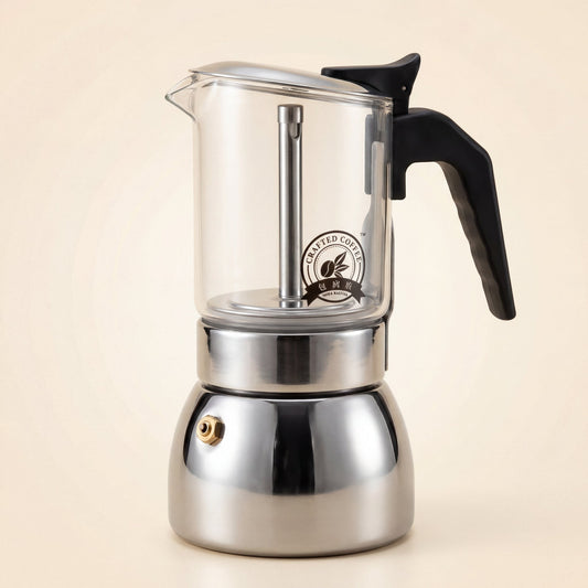 Cafetière italienne à chambre supérieure en verre borosilicate et base en inox, poignée noire, vue de trois-quarts.